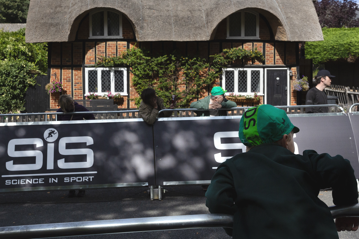 Tour of Britain 2025 - A young fan leans over the barrier in anticipation of the race’s arrival