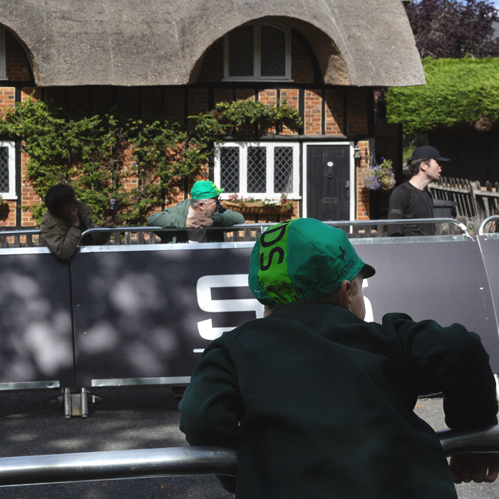 Tour of Britain 2025 - A young fan leans over the barrier in anticipation of the race’s arrival