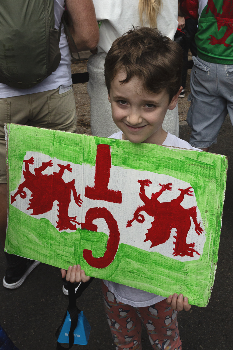 Tour of Britain 2025 - A young fan holds a Welsh Dragon themed sign in honour of Geraint Thomas