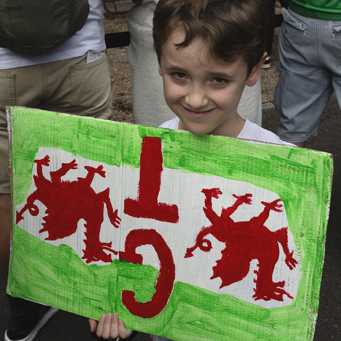 Tour of Britain 2025 - A young fan holds a Welsh Dragon themed sign in honour of Geraint Thomas