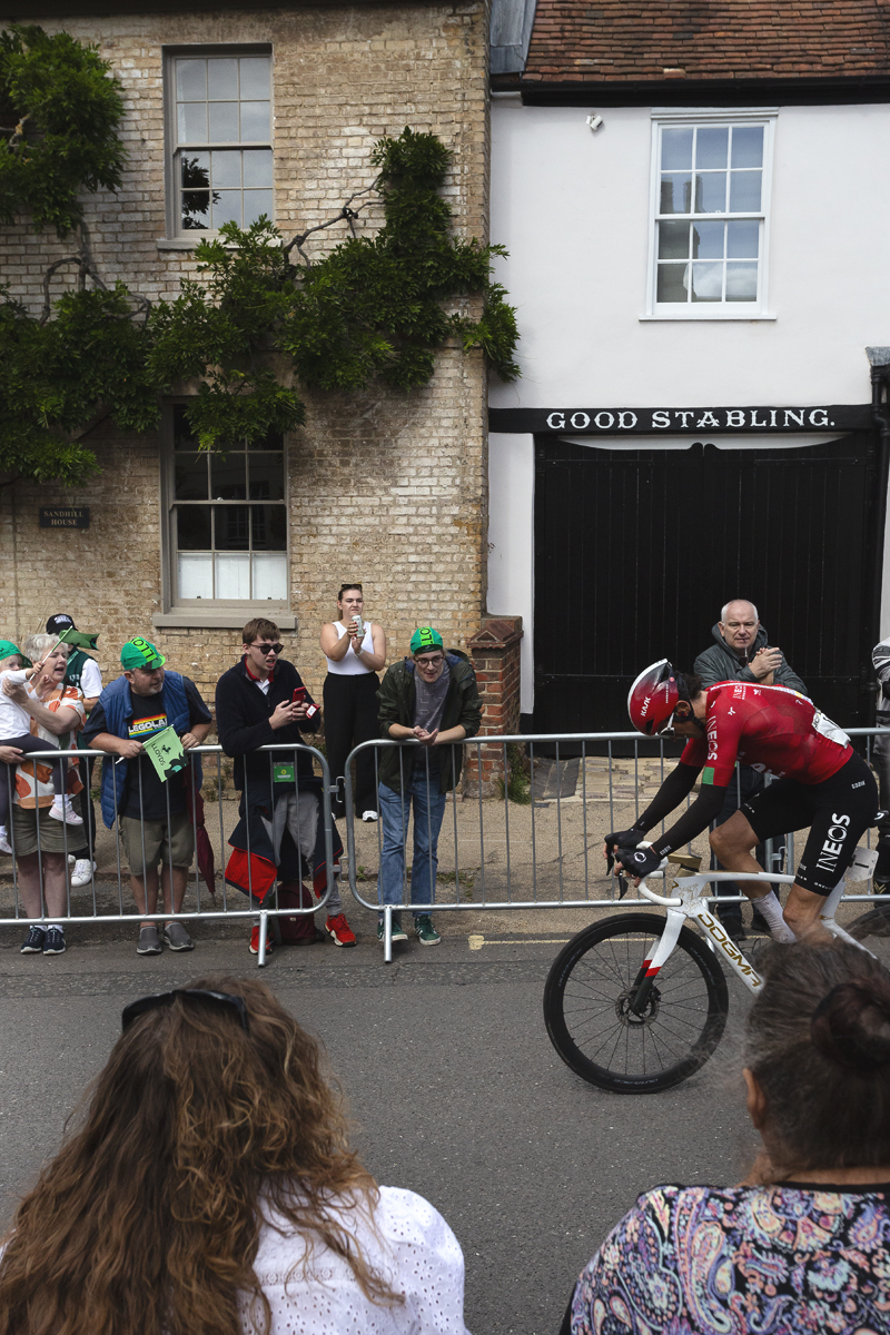 Tour of Britain 2025 - Geraint Thomas with his head down rides past cheering fans