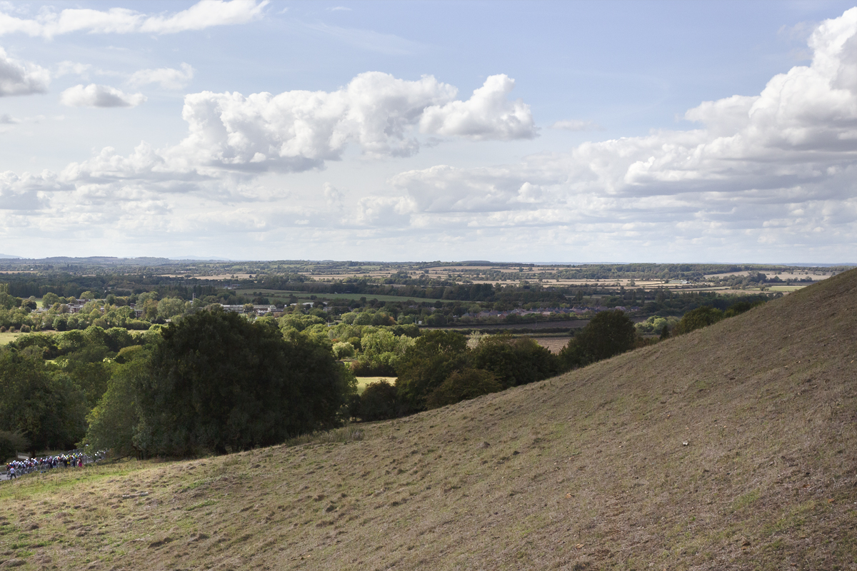 Tour of Britain 2025 - Riders seen in the distance fro the vantage point of a hill at Burton Dassett