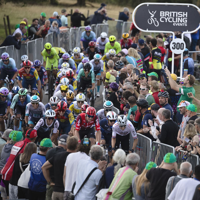 Tour of Britain 2025 - Crowds lean in to catch a view of the riders as they make the final push up the hill towards the finish at Burton Dassett