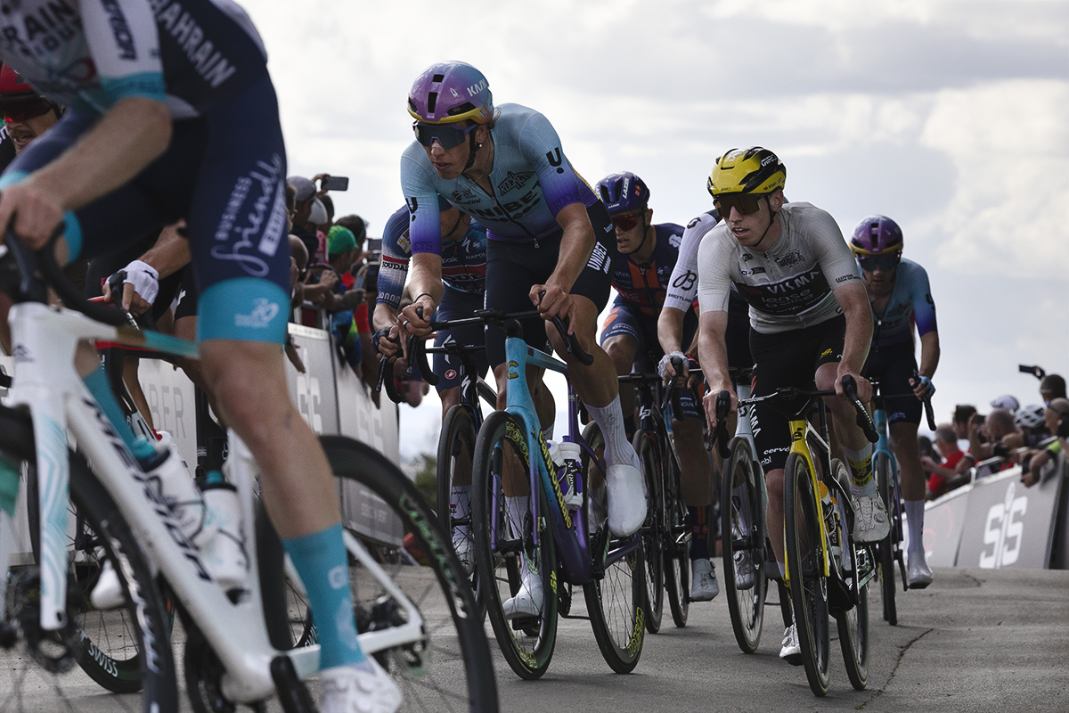 Tour of Britain 2025 Matthew Brennan and Tomáš Kopecký pass hoarding lined with fans on their climb up Burton Dassett