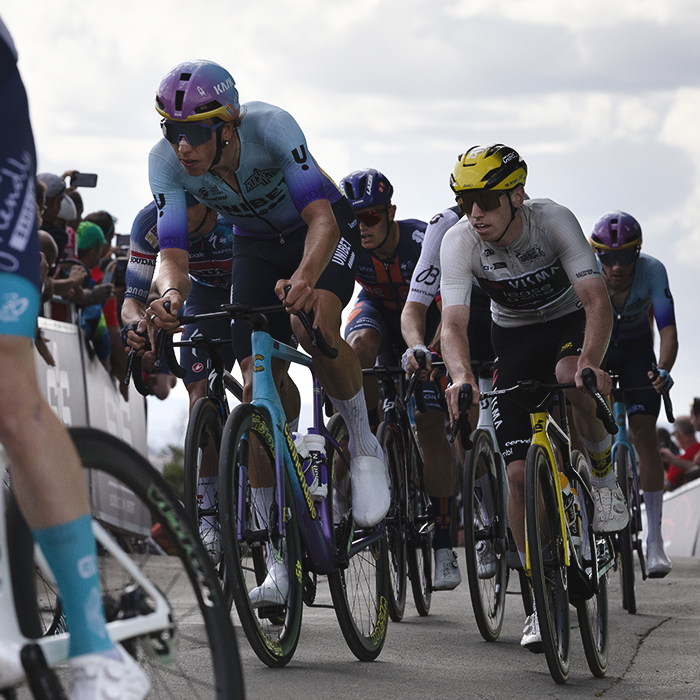 Tour of Britain 2025 Matthew Brennan and Tomáš Kopecký pass hoarding lined with fans on their climb up Burton Dassett