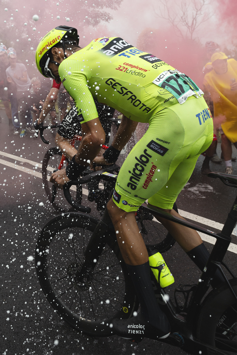Tour of Britain 2025 - Rafael Reis is greeted by champagne and flares on his way up the mountain