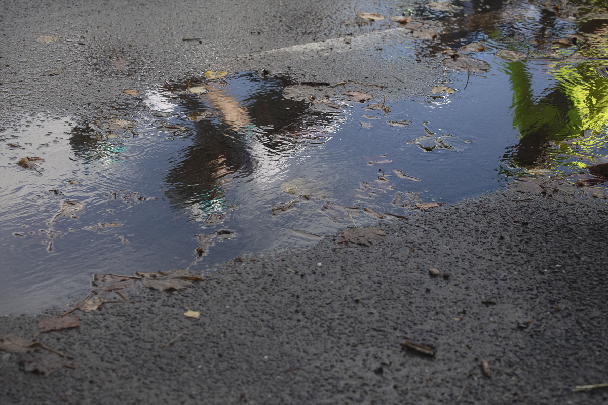 Tour of Britain 2025 - The reflection of a rider in a puddle after heavy rainfall earlier in the day