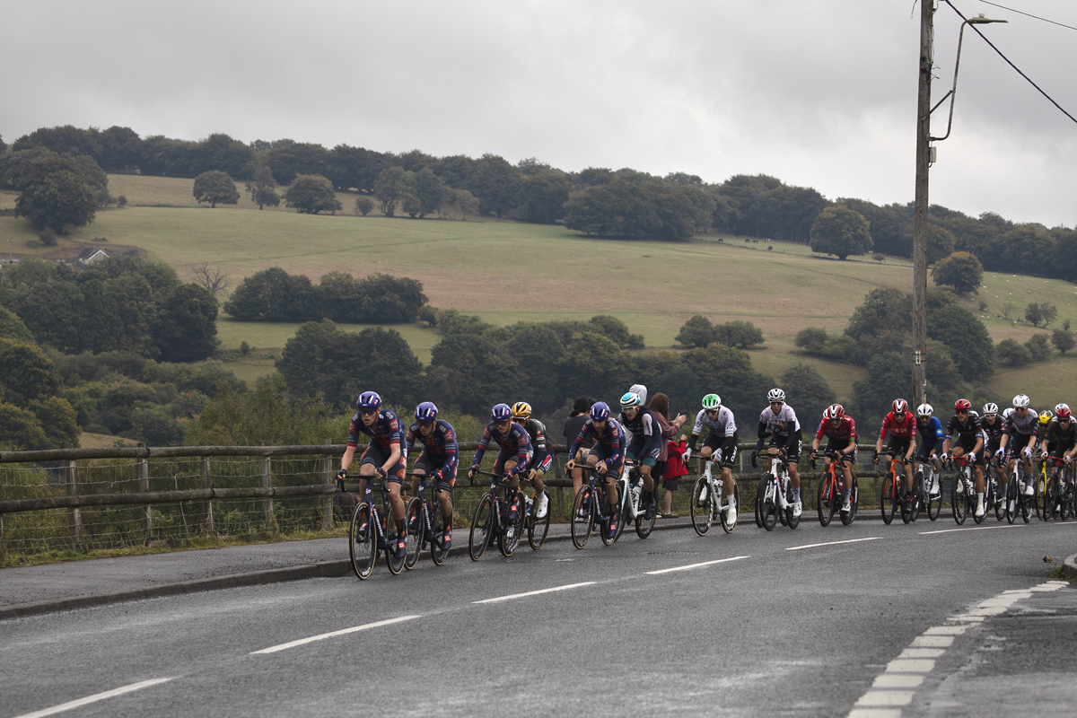 Tour of Britain 2025 - The peloton passes by beautiful Welsh countryside in Markham