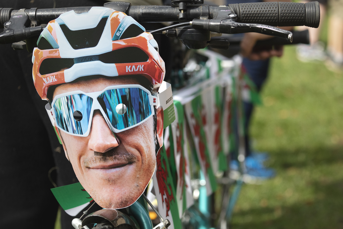 Tour of Britain 2025 - A Tandem bike is adorned with Welsh flag bunting and a Geraint Thomas mask