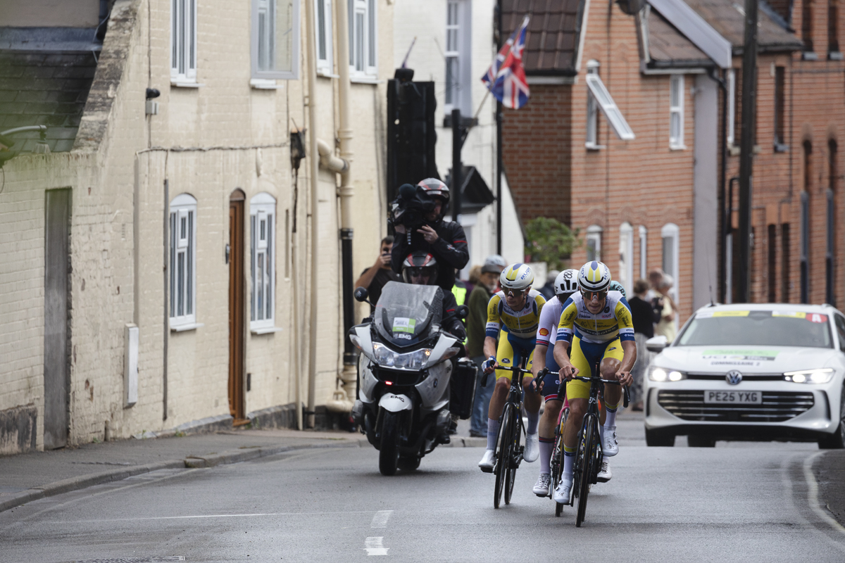 Tour of Britain 2025 - The breakaway lead by Milan Lanhove & Victor Vercouillie ride through Saxmundham, a Union flag seen behind them
