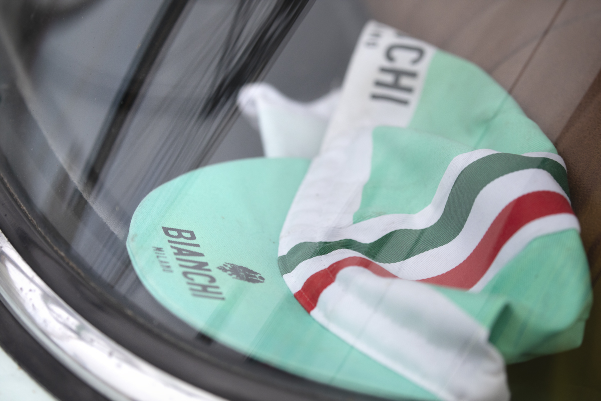 Tour of Britain 2025 - A Bianchi hat seen through the window of an Alfa-Romeo