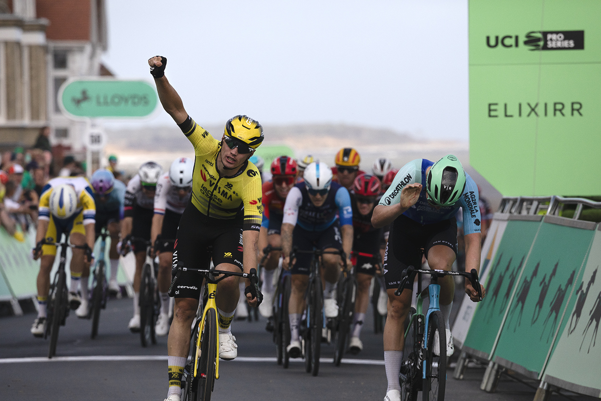 Tour of Britain 2025 - Olav Kooij raises his fist in victory while Tord Gudmestad bangs his bike in frustration