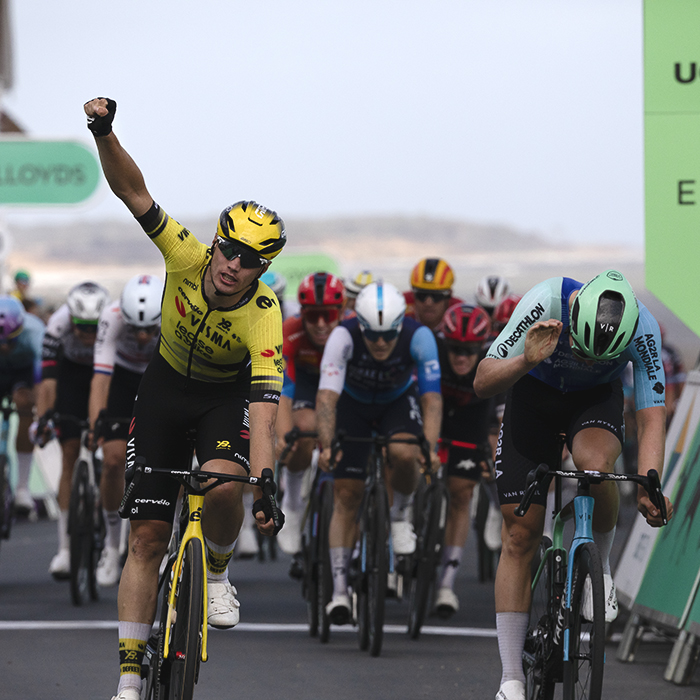 Tour of Britain 2025 - Olav Kooij raises his fist in victory while Tord Gudmestad bangs his bike in frustration