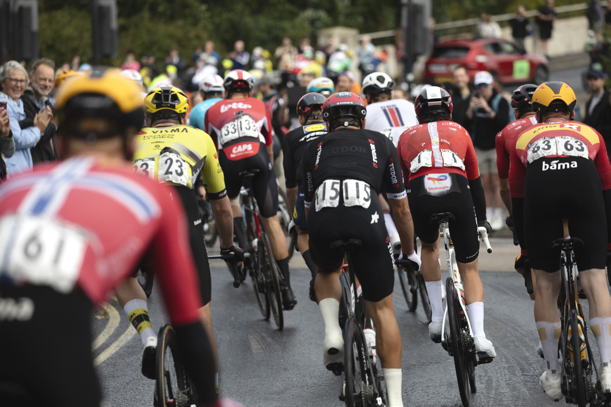 Tour of Britain 2025 - A view of the peloton from behind as it leaves Stowmarket