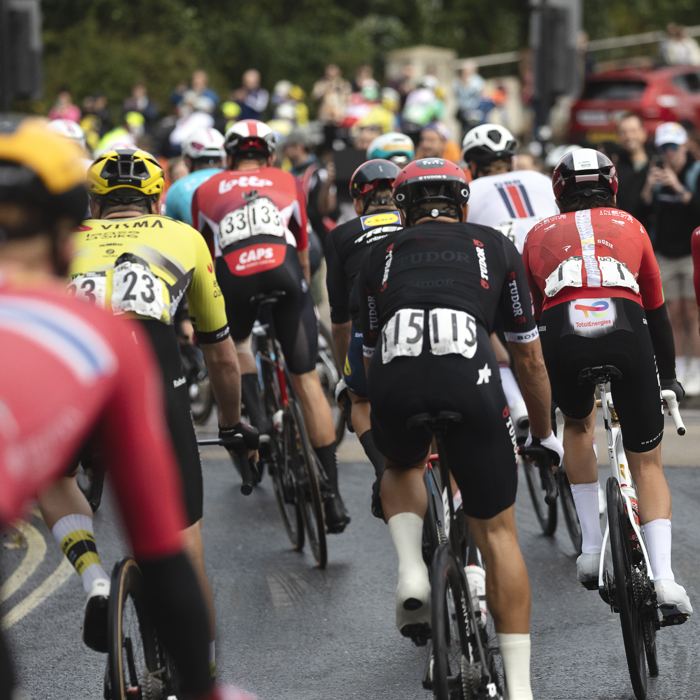 Tour of Britain 2025 - A view of the peloton from behind as it leaves Stowmarket