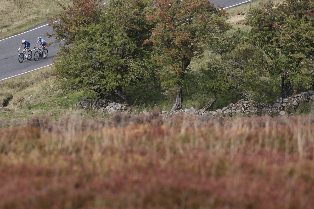 Tour of Britain 2025 - Riders are viewed on the road beneath the steep moorland