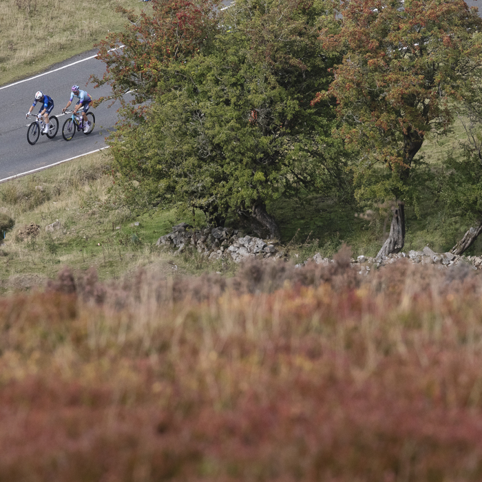 Tour of Britain 2025 - Riders are viewed on the road beneath the steep moorland