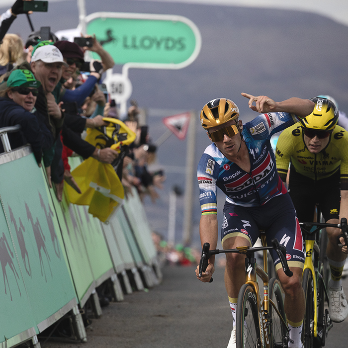 Tour of Britain 2025 - Remco Evenepoel raises his finger in the air as he crosses the line victorious