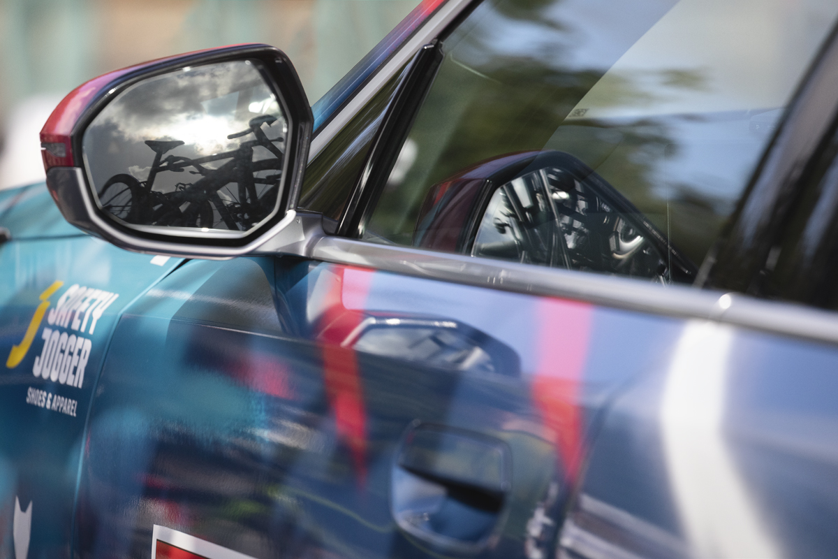 Tour of Britain 2025 - A Soul Quick-Step team car with bikes reflected in its wing mirror