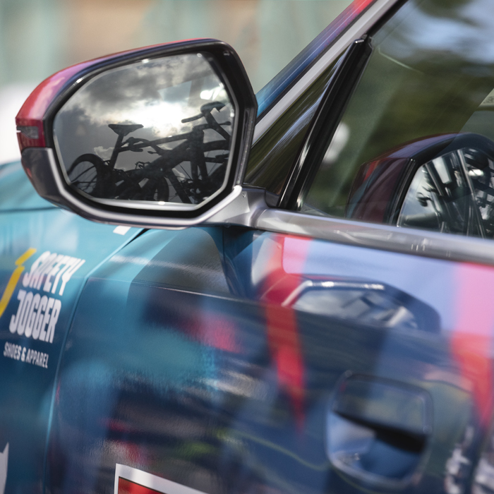 Tour of Britain 2025 - A Soul Quick-Step team car with bikes reflected in its wing mirror