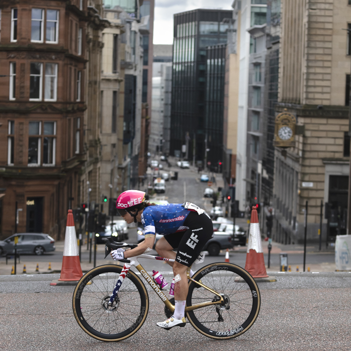 Tour of Britain Women’s 2025 - Stage 4 - Kristen Faulkner races through the streets of Glasgow with tall city buildings as a backdrop
