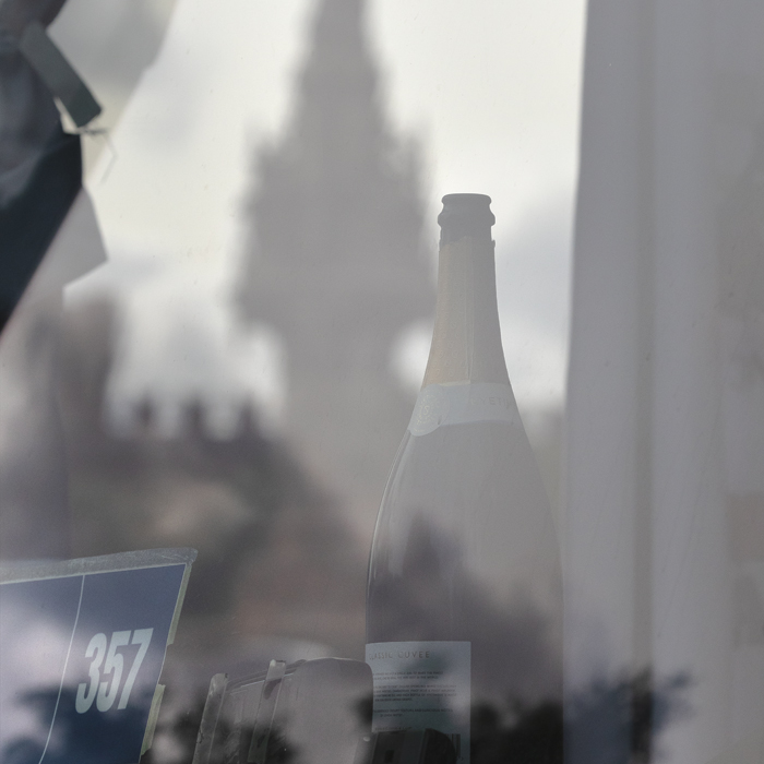 Tour of Britain Women’s 2025 - Stage 4 - An empty champagne bottle in the front of a team bus with Doulton Fountain in the background
