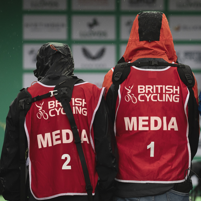 Tour of Britain Women’s 2025 - Stage 3 - Sodden photographers stand on a raised flower bed in Kelso