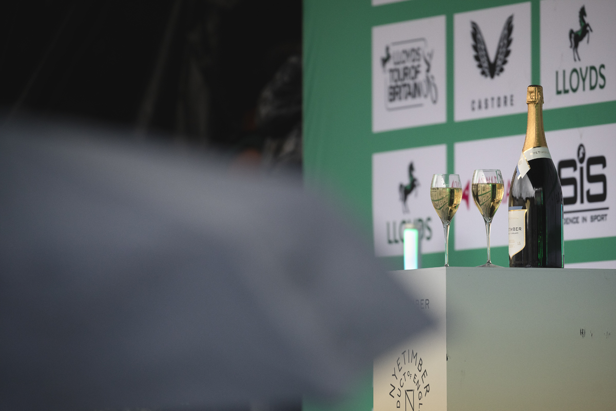 Tour of Britain Women’s 2025 - Stage 3 - Glasses and a bottle of wine on the podium in Kelso