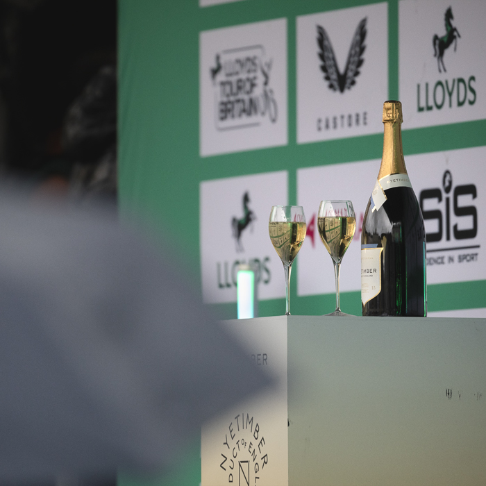 Tour of Britain Women’s 2025 - Stage 3 - Glasses and a bottle of wine on the podium in Kelso