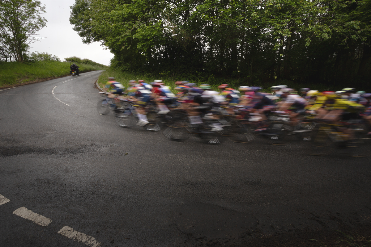 Tour of Britain Women’s 2025 - Stage 3 - Riders speed round a corner heading towards Lillisleaf