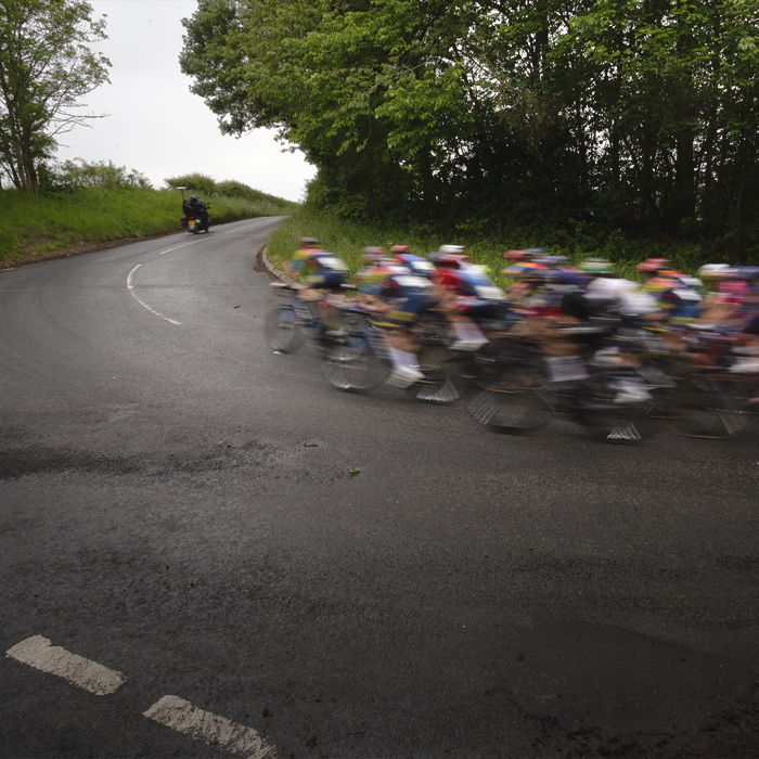 Tour of Britain Women’s 2025 - Stage 3 - Riders speed round a corner heading towards Lillisleaf