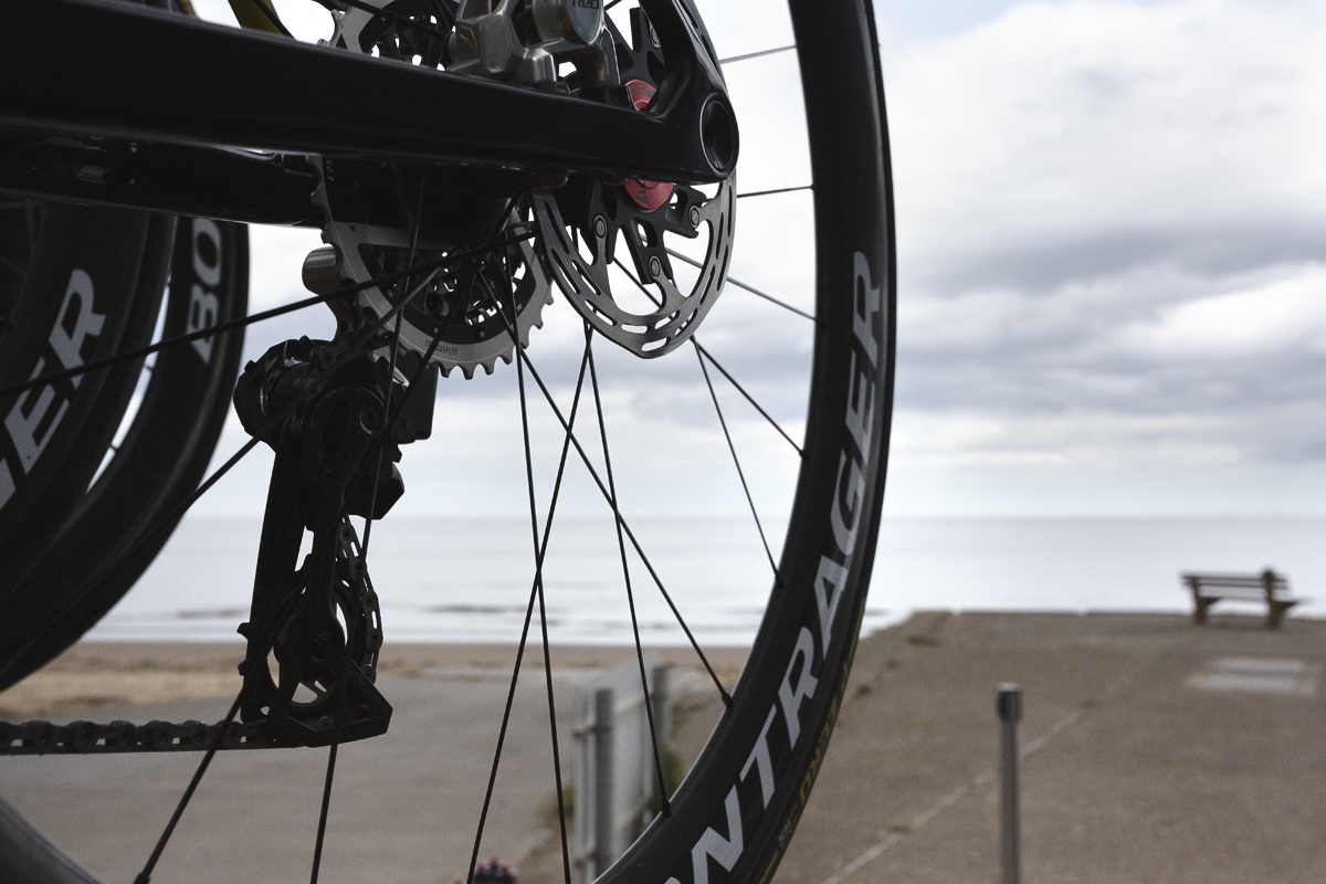 Tour of Britain Women’s 2025 - Stage 1 - The seafront at Redcar with a bike wheel in the foreground