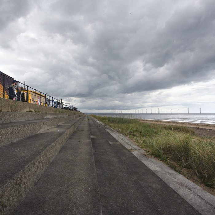 Tour of Britain Women’s 2025 - Stage 1 - Team buses line the seafront in Redcar with the steps down to the beach in the foreground