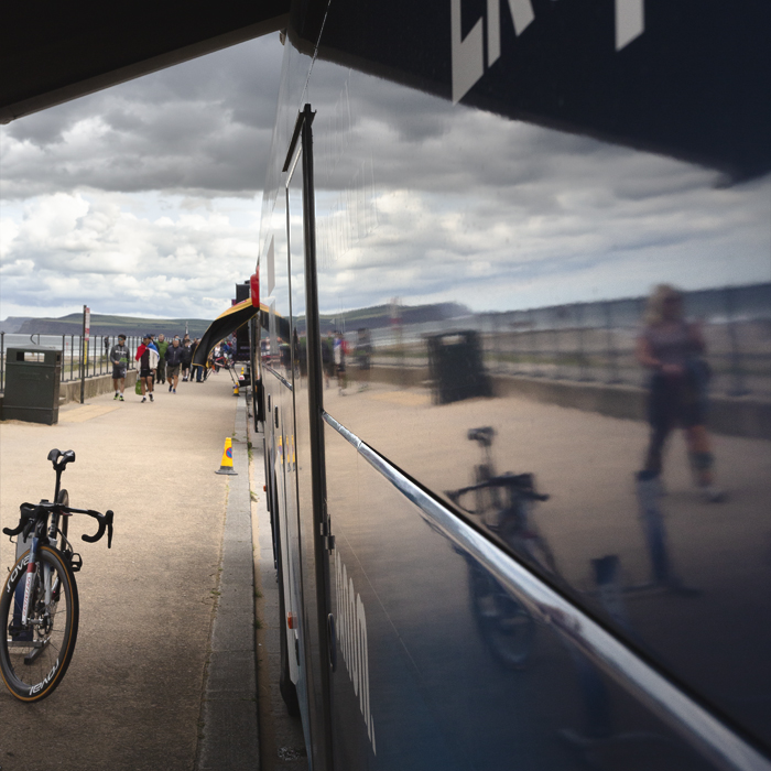 Tour of Britain Women’s 2025 - Stage 1 - Redcar Reflections; the seafront is reflected in the side of a team bus