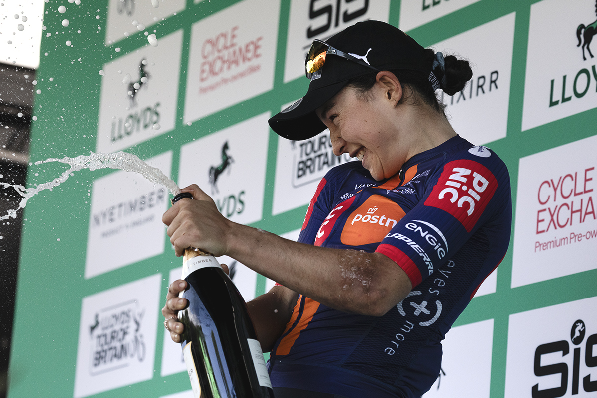 Tour of Britain Women’s 2025 - Stage 2 - Mara Roldan celebrates with a bottle of fizzy wine on the podium