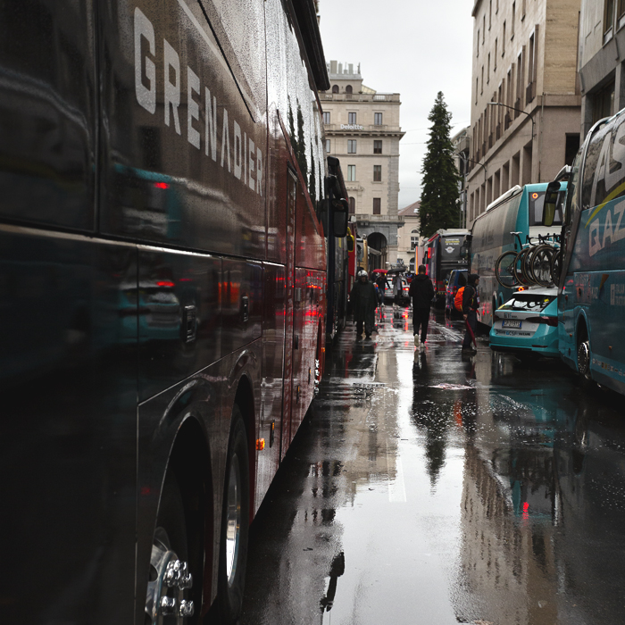 Tre Valli Varesine 2024 - The INEOS Grenadiers bus with the backdrop of Varese  reflected in the wet streets