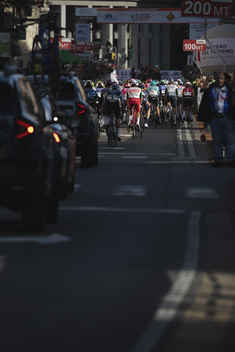 Tre Valli Varesine 2025 - The peloton from the race convoy is lit by the autumnal sun