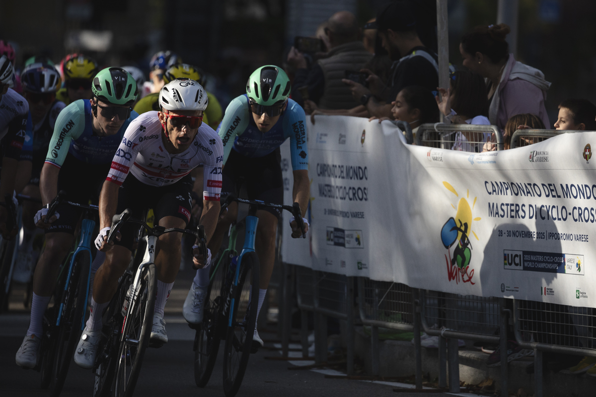 Tre Valli Varesine 2025 - Rafał Majka leads a group of riders through the streets of Varese