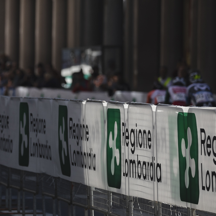Tre Valli Varesine 2025 - The hoardings advertising Regione Lombardia glint in the autumnal sunlight