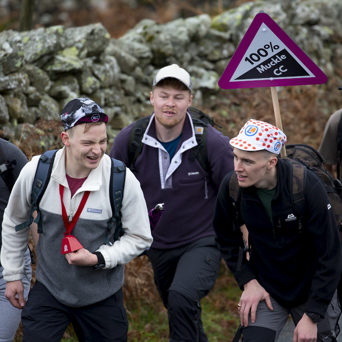 UK National Hill Climb Championships 2023 - A group of fans carry a road sign that reads 100% Muckle