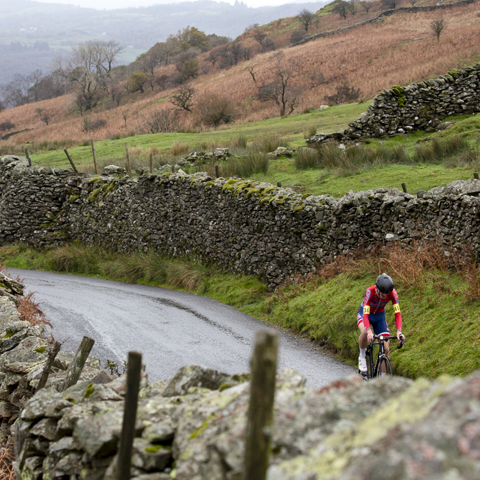 UK National Hill Climb Championships 2023 - Ben McKie passes by dry stone walls with the countryside in the background