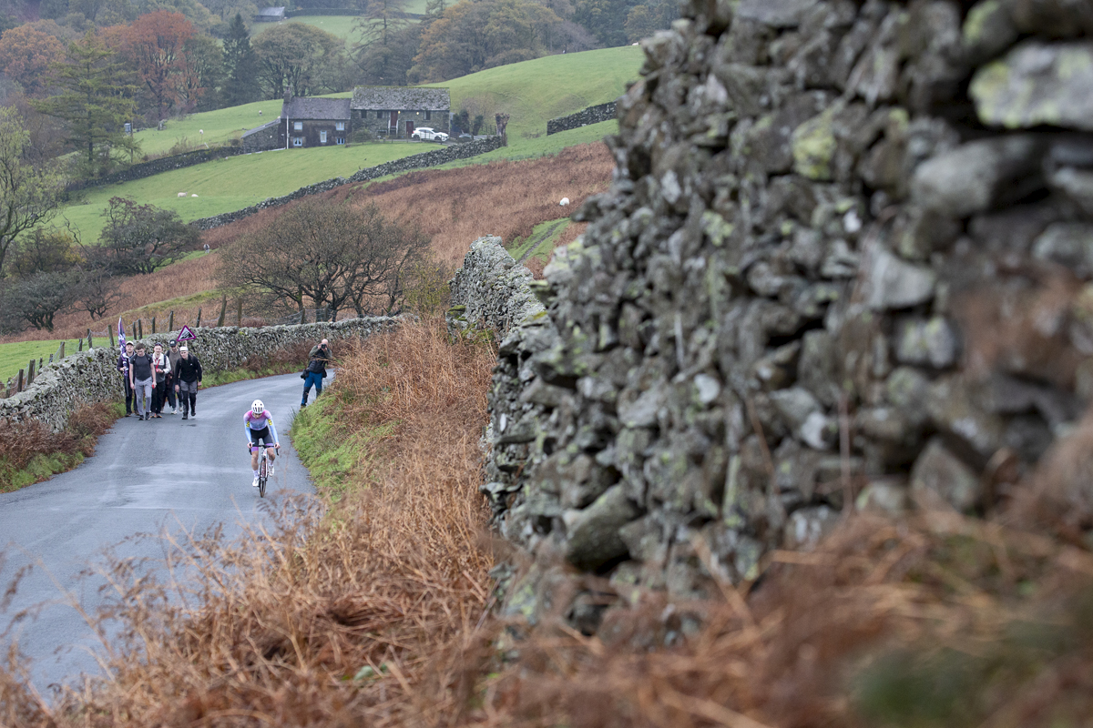 UK National Hill Climb Championships 2023 - Frances Owen on The Struggle with a Cumbrian farmhouse in the distance behind her