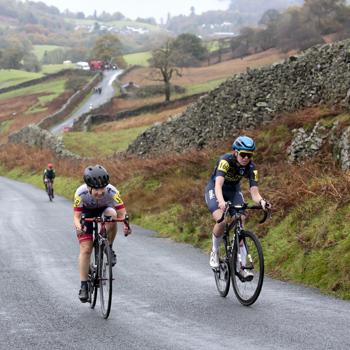 UK National Hill Climb Championships 2023 - Wiebke Rietz & Lilja Raine make their way up The Struggle with the road winding through the countryside in the background